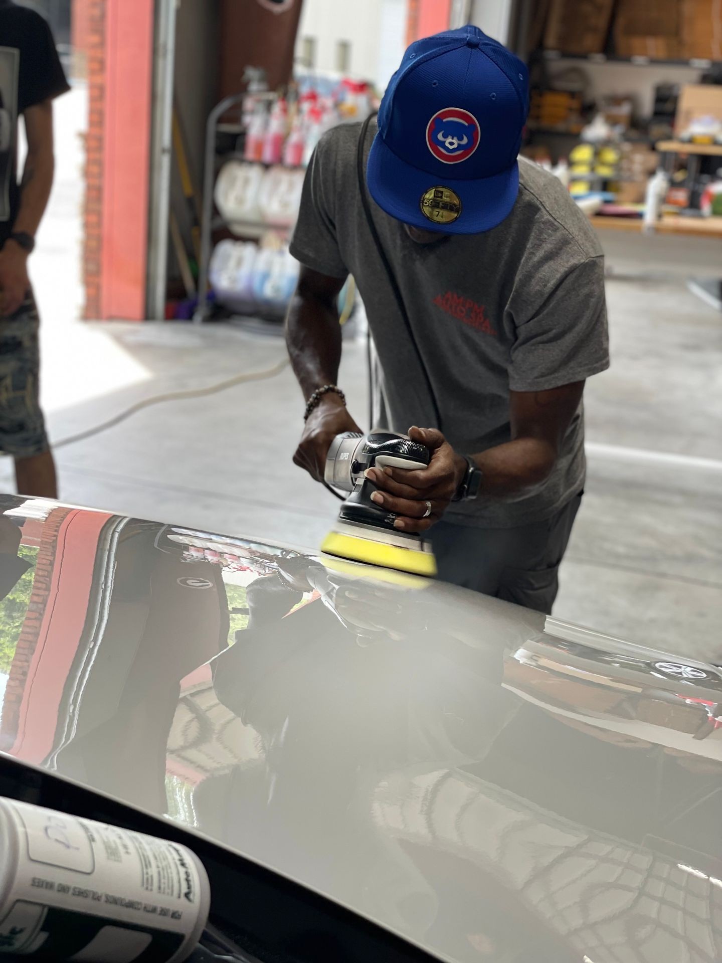 man polishing car surface